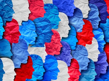 shapes of human heads cut out of wrinkled paper red white and blue