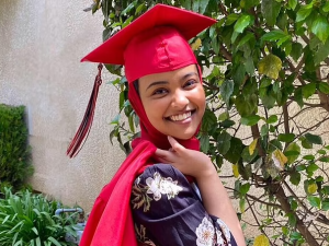 USC Valedictorian Asna Tabassum wearing a red graduation cap