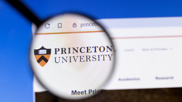 Princeton University website homepage logo visible on display screen under a magnifying glass