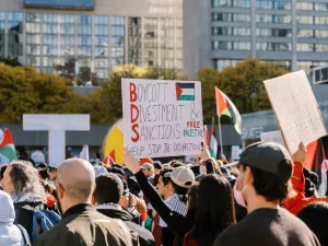 Protesters march in the city holding signs advocating for Boycott Divestment and Sanctions on October 28, 2023