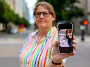 Photo of FIRE plaintiff Susan Hogarth holding up her phone showing her ballot selfie