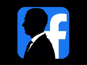 silhouette of Mark Zuckerberg in front of the Facebook logo