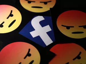 Facebook logo surrounded by angry face emojis