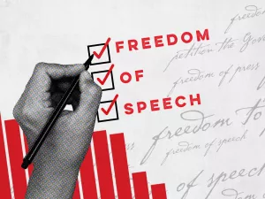 Bar graphs on a sheet of paper with a hand writing "Freedom of Speech"