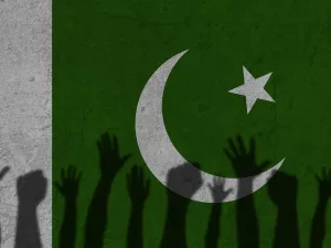 Protesters hands shadow on Pakistan flag