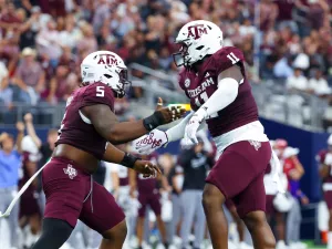 Texas A&M Aggies defensive linemen celebrate during the first half against the Arkansas Razorbacks