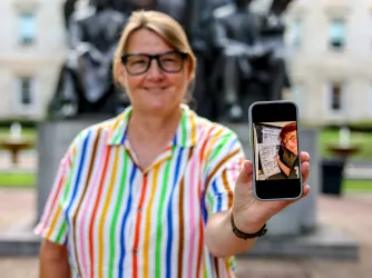 Photo of FIRE plaintiff Susan Hogarth holding up her phone showing her ballot selfie