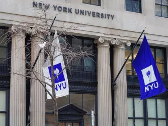 View of a purple school flag on the campus on New York University in Manhattan