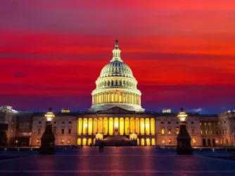 The United States Capitol building at sunset at night in Washington DC