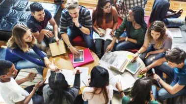 college students sitting in a circle studying and discussing