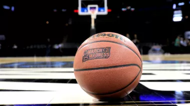 March Madness basketball on court