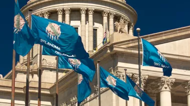 Oklahoma capitol building with state flags flying