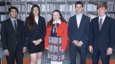 Group of college students standing in FIRE headquarters