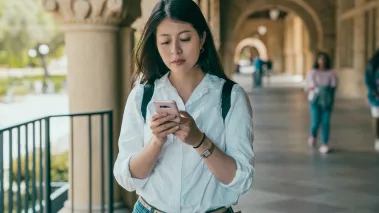 Stanford University student checking mobile phone notifications