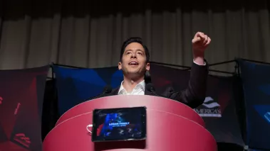 Daily Wire host Michael Knowles speaking at a podium