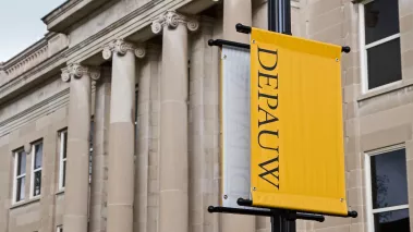 Emison Hall at Depauw University with a university banner hanging from a light post