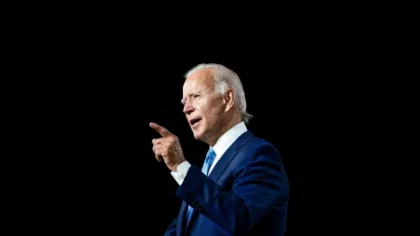 President Joe Biden speaking against a black background