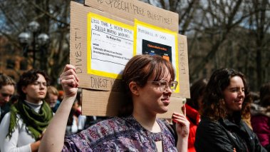 University of Michigan PhD student Allison Cale, center, carries a sign that says Free Speech! Free Palestine! as students walk out to protest university administration's proposed disruptive activity policy at U-M's Diag in Ann Arbor on Thursday, April 4, 2024.
