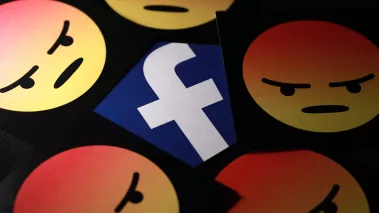 Facebook logo surrounded by angry face emojis