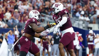 Texas A&M Aggies defensive linemen celebrate during the first half against the Arkansas Razorbacks