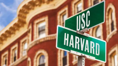 Street sign reading Harvard and USC, concept indicating colleges are at a crossroads