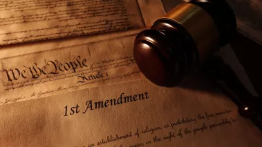 First Amendment and US Constitution historic documents with legal gavel