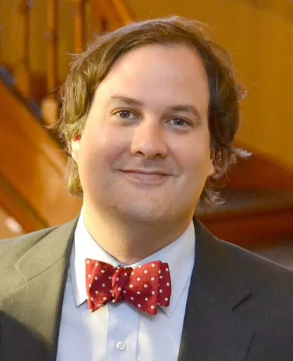 Photo of Enrique Armijo wearing a red bowtie