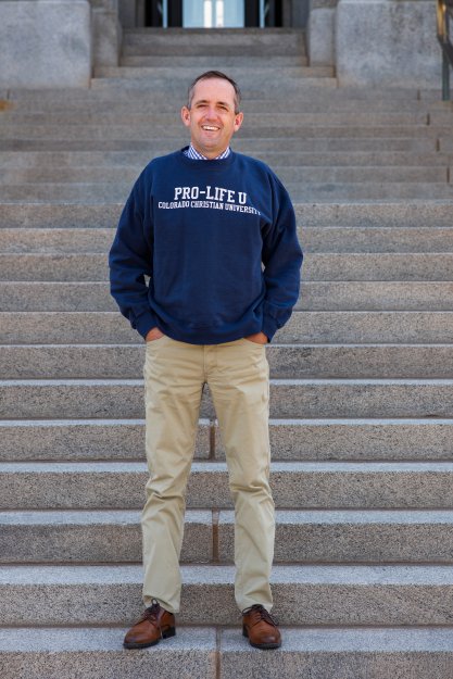 Jeff Hunt standing on stairs wearing "Pro Life U" sweatshirt