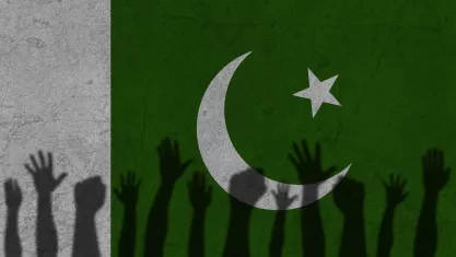 Protesters hands shadow on Pakistan flag