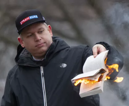 Rasmus Paludan burning a Quran outside the Turkish embassy in Stockholm in January 2023 