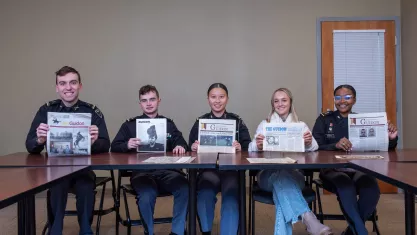 Norwich University Students Holding Up Copies of the student newspaper "The Guidon"