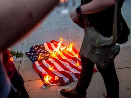 Protesters burning the American flag.