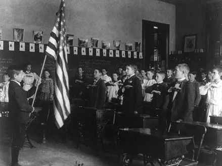 Group of children reciting pledge of allegiance to the flag in 1899