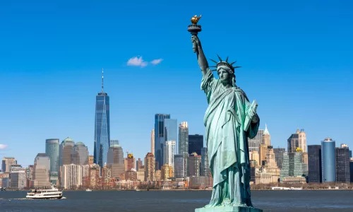 The Statue of Liberty over the Scene of New York cityscape river side which location is lower manhattan.