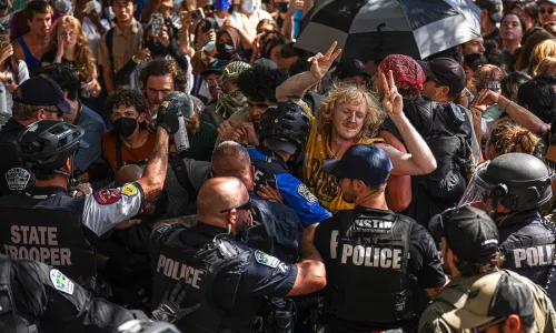 Protesters block police vehicles from leaving the University of Texas at Austin on Monday, April 29, 2024