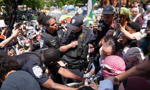 George Washington University Police officers tussle with protesters who tried to raise the Palestinian flag on the campus flagpole