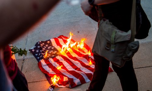 Protesters burning the American flag.