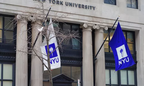 View of a purple school flag on the campus on New York University in Manhattan