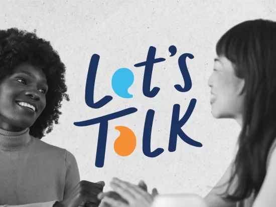 Two women smiling and talking with the phrase "Let's Talk" between them.