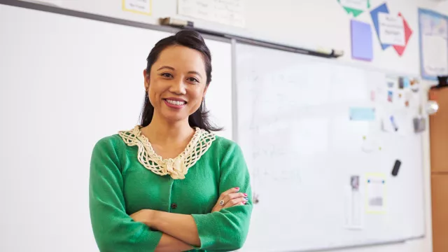 teacher standing in front of white board