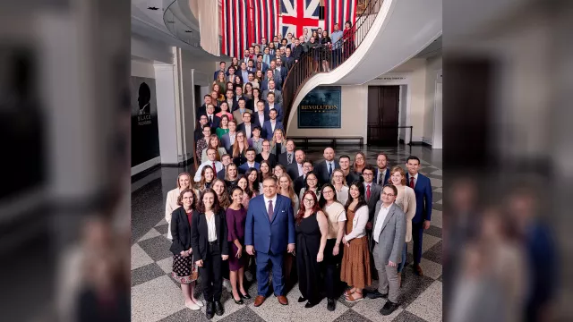 Group photo of FIRE's staff on the grand staircase at the Museum of the American Revolution