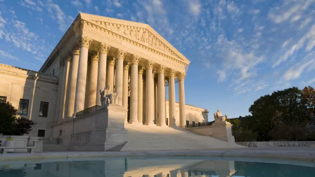 The front of the US Supreme Court in Washington, DC, at dusk.